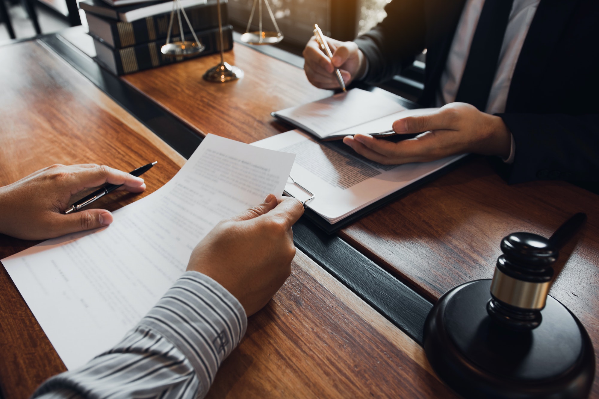 Lawyer is providing information about the client's trial at the lawyer office.
